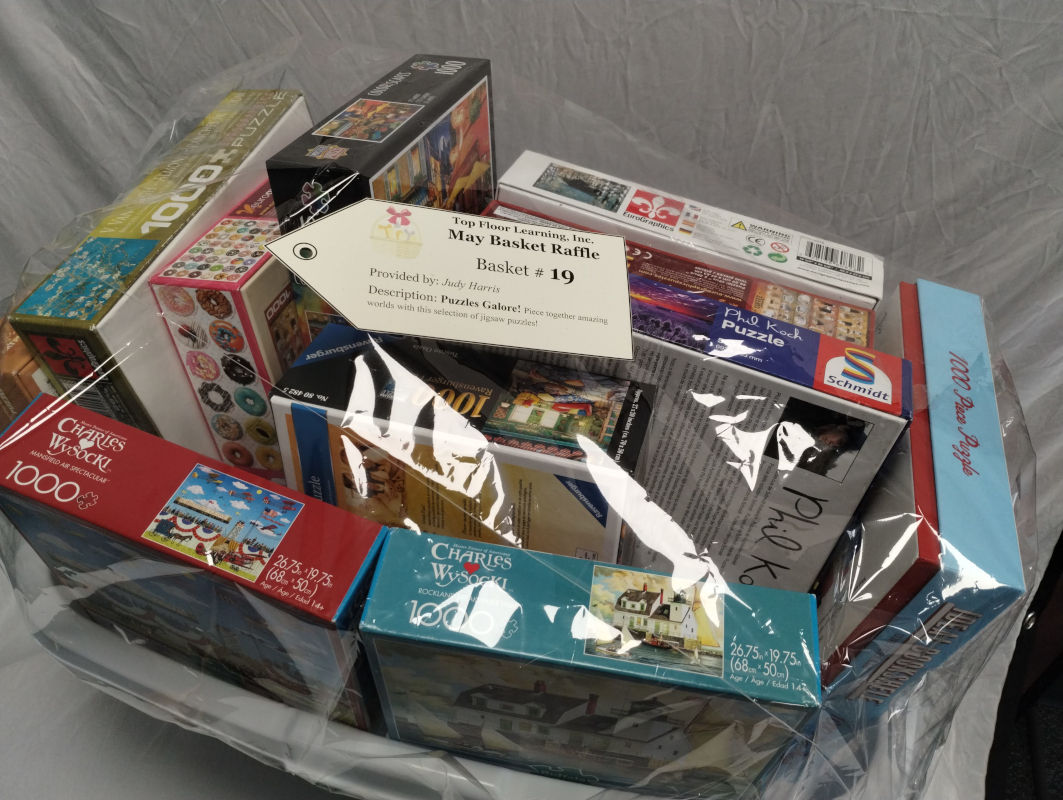 laundry basket stuffed full of boxed jigsaw puzzles of various themes.