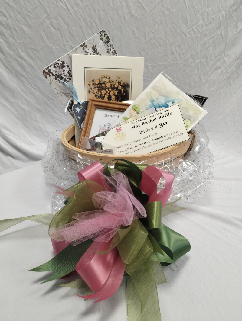 a small basket with an art print of sunflowers sticking out, along with notecards, small framed items, and more.