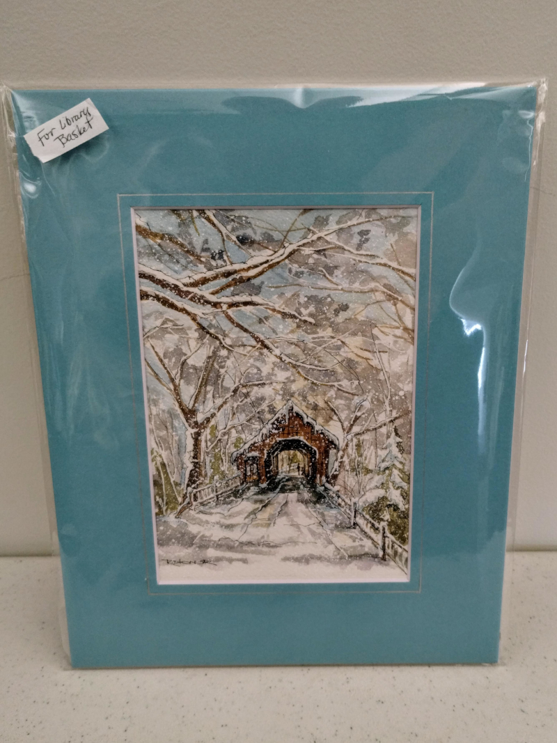 a watercolor of a snowy covered bridge in a light blue colored mat